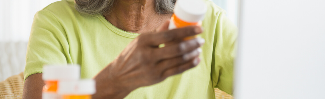 person looking at medicine bottle